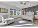 Bedroom features a white bed, white walls, hardwood floors, and a sitting area with a white chair at 112 Ocean Blvd, Isle of Palms, SC 29451