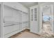 Bright walk-in closet with vanity and makeup station, closet rods, shelves and a view at 112 Ocean Blvd, Isle of Palms, SC 29451