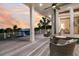 Spacious covered deck featuring outdoor seating and breathtaking sunset views of the ocean and beach at 112 Ocean Blvd, Isle of Palms, SC 29451