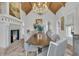 Elegant dining room featuring a long wooden table, upholstered chairs, and a fireplace at 112 Ocean Blvd, Isle of Palms, SC 29451