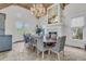 Dining room with vaulted ceilings, a chandelier, fireplace, and a long wooden table with seating at 112 Ocean Blvd, Isle of Palms, SC 29451