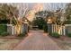 Inviting driveway entrance with brick pavers, manicured hedges, and elegant lighting at 112 Ocean Blvd, Isle of Palms, SC 29451