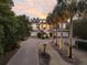 Elegant exterior featuring professional landscaping, well lit with a brick drive way at 112 Ocean Blvd, Isle of Palms, SC 29451