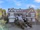 Elegant home with a grand staircase, manicured landscaping, and attached garage in a desirable coastal location at 112 Ocean Blvd, Isle of Palms, SC 29451