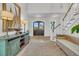 Inviting foyer with dark wood doors, decorative rug, stairs, and display cabinet with nautical accents at 112 Ocean Blvd, Isle of Palms, SC 29451