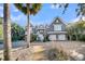 Beautiful two-story home with a three-car garage, brick driveway and stunning landscaping at 112 Ocean Blvd, Isle of Palms, SC 29451
