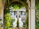 A charming home facade framed by lush greenery and an arbor at 112 Ocean Blvd, Isle of Palms, SC 29451