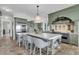 Bright kitchen with a large island with seating, stainless steel appliances, and custom cabinetry at 112 Ocean Blvd, Isle of Palms, SC 29451