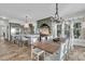 Gourmet kitchen featuring stainless steel appliances, large island, and adjacent dining area at 112 Ocean Blvd, Isle of Palms, SC 29451