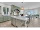 Coastal kitchen with a large center island, white countertops, green cabinetry, and modern appliances at 112 Ocean Blvd, Isle of Palms, SC 29451