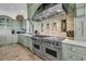 Modern kitchen with stainless steel range, tile backsplash, and custom cabinetry at 112 Ocean Blvd, Isle of Palms, SC 29451
