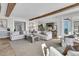 Open-concept living room with wood beams, neutral decor, and seamless flow to kitchen and dining areas at 112 Ocean Blvd, Isle of Palms, SC 29451