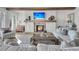 Comfortable living room with a fireplace, TV, wood beams, and stylish decor at 112 Ocean Blvd, Isle of Palms, SC 29451