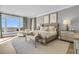 Bright main bedroom with a luxurious bed, chaise lounge, and ocean views at 112 Ocean Blvd, Isle of Palms, SC 29451