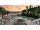 Pool area with beach view in fenced-in yard has chairs, and an outdoor table near the beach at 112 Ocean Blvd, Isle of Palms, SC 29451