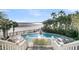 Elevated view of a serene pool with palm trees and ocean view at 112 Ocean Blvd, Isle of Palms, SC 29451