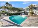 A large pool and hot tub sit outside of this beautiful home, surrounded by palm trees at 112 Ocean Blvd, Isle of Palms, SC 29451