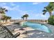 This luxurious pool area overlooks the ocean and features a pool, hot tub, and lounge chairs at 112 Ocean Blvd, Isle of Palms, SC 29451