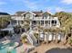 Luxury home featuring a pool, hot tub, and multi-level deck with outdoor seating and multiple staircases at 112 Ocean Blvd, Isle of Palms, SC 29451