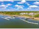 Scenic aerial view of a waterfront community with private boat docks and luxurious residences against a bright blue sky at 130 River Landing Dr # 5108, Charleston, SC 29492