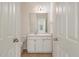 Bathroom with a white vanity, sink, mirror, and an open doorway at 130 River Landing Dr # 5108, Charleston, SC 29492