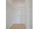 Walk-in closet with white walls, light wood floors, and wire shelving at 130 River Landing Dr # 5108, Charleston, SC 29492