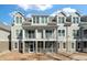 Exterior of townhome featuring double balconies and screened in patio with a blue sky at 130 River Landing Dr # 5108, Charleston, SC 29492