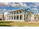 Beautiful multi-story building with outdoor dining space, lush landscaping, and pristine lawn at 130 River Landing Dr # 5108, Charleston, SC 29492