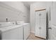 Laundry room with washer, dryer, shelves, and storage cabinets at 130 River Landing Dr # 5108, Charleston, SC 29492