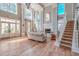 Elegant living room featuring soaring ceilings, a fireplace, hardwood floors, and staircase at 130 River Landing Dr # 5108, Charleston, SC 29492