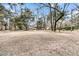 Large backyard with mature trees, a fenced area, and a spacious lawn at 135 Rapture Ln, Wando, SC 29492
