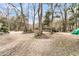 Long gravel driveway leading up to a country home, surrounded by mature trees and natural scenery at 135 Rapture Ln, Wando, SC 29492