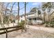 Rear exterior of the two-story home featuring a porch, white siding, and lush landscaping at 135 Rapture Ln, Wando, SC 29492