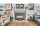 Cozy fireplace with decorative mantle, tile surround, and floral armchair at 135 Rapture Ln, Wando, SC 29492