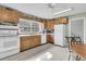 Well-lit kitchen featuring wood cabinets, white appliances, and tile flooring at 135 Rapture Ln, Wando, SC 29492