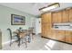 Eat-in kitchen with light wood cabinetry, tile floors, and a breakfast table at 135 Rapture Ln, Wando, SC 29492