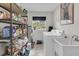 Functional laundry room featuring shelving, a sink, and a washing machine with natural lighting at 135 Rapture Ln, Wando, SC 29492