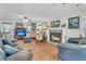 Cozy living room with a fireplace, hardwood floors, and ample seating, creating a comfortable gathering space at 135 Rapture Ln, Wando, SC 29492