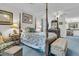 Spacious main bedroom featuring a four-poster bed, en-suite bathroom, and soft carpeting at 135 Rapture Ln, Wando, SC 29492