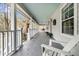 Inviting wrap-around porch with classic white railings, offering an ideal spot for relaxing at 135 Rapture Ln, Wando, SC 29492