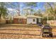 Rear exterior view of the home showing the fenced backyard with shed, fire pit, and patio furniture at 137 Dowling Ave, Walterboro, SC 29488