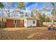 View of the backyard with a patio set, fenced perimeter, and a mix of brick and siding on the home's exterior at 137 Dowling Ave, Walterboro, SC 29488