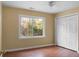 Bedroom features a ceiling fan, closet with double doors, wood laminate flooring, and a window with outdoor views at 137 Dowling Ave, Walterboro, SC 29488