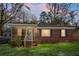 Charming brick home featuring a screened-in porch and well-maintained front yard at 137 Dowling Ave, Walterboro, SC 29488