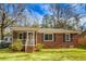 Charming brick home featuring a screened-in porch and well-maintained front yard at 137 Dowling Ave, Walterboro, SC 29488