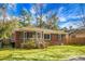 Charming brick home featuring a screened-in porch and well-maintained front yard at 137 Dowling Ave, Walterboro, SC 29488