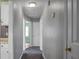 Hallway view with grey walls, white trim, doors and grey carpet at 137 Dowling Ave, Walterboro, SC 29488