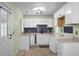 Charming kitchen with white cabinets and black backsplash is perfect for any home cook at 137 Dowling Ave, Walterboro, SC 29488