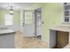 Eat-in kitchen features light green walls, a white door and cabinets with light granite countertops at 137 Dowling Ave, Walterboro, SC 29488