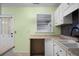 Well-lit kitchen with white cabinets, black hardware and backsplash, with sink and granite countertops at 137 Dowling Ave, Walterboro, SC 29488